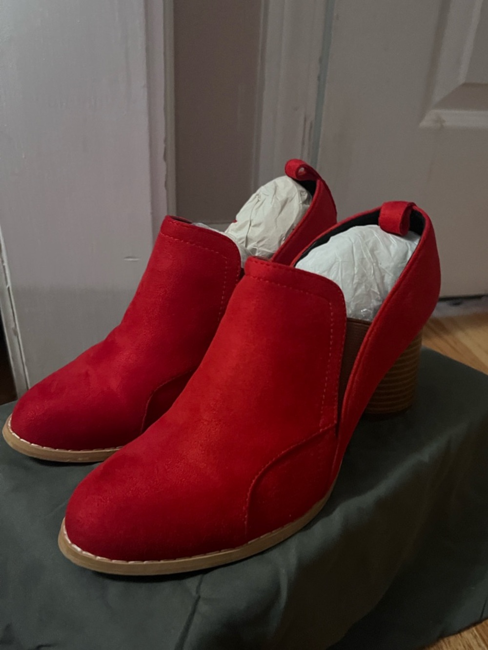Red suede designer ankle boots with block heel.
